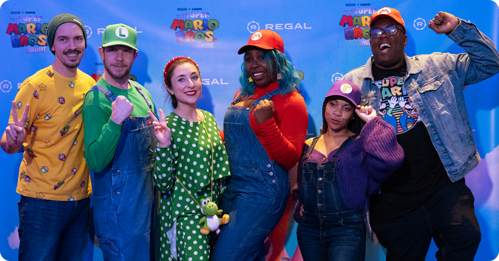 Influencers dressed in Mario-themed clothes posing in a group
