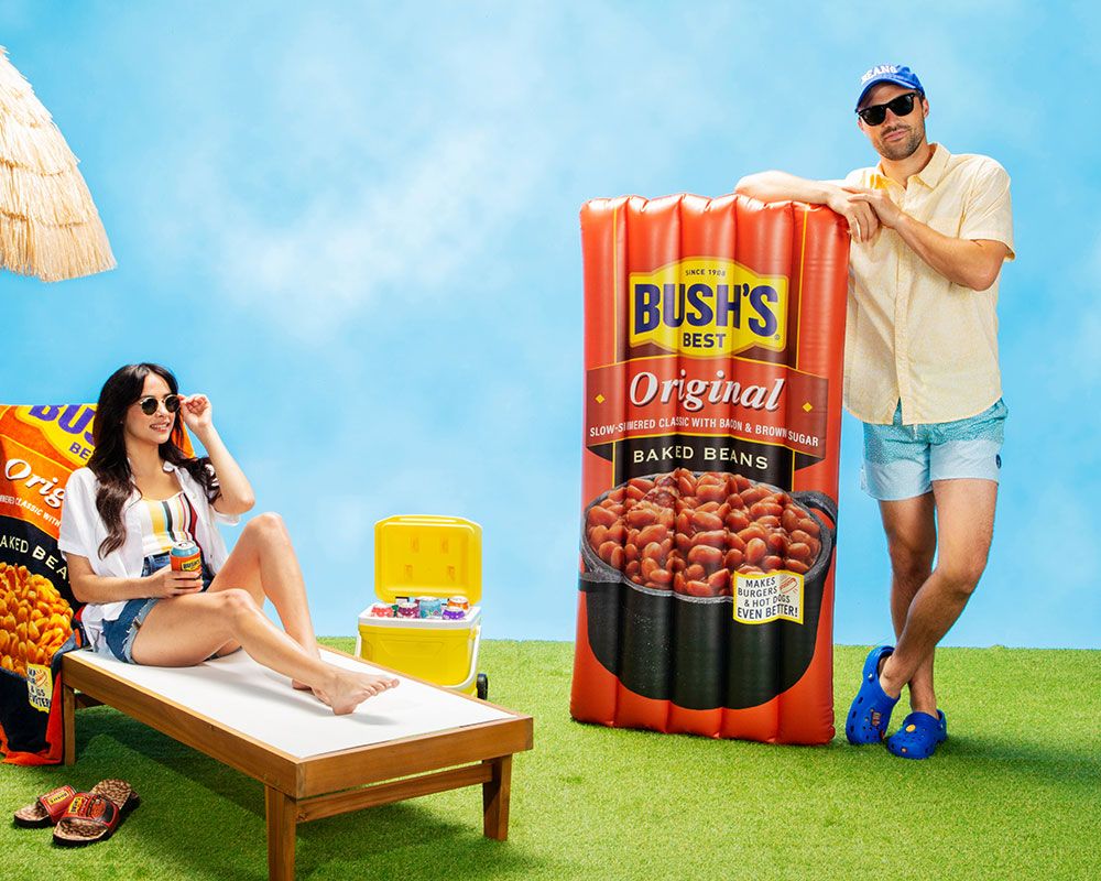Man and woman relaxing outside with Bush's beans merch.