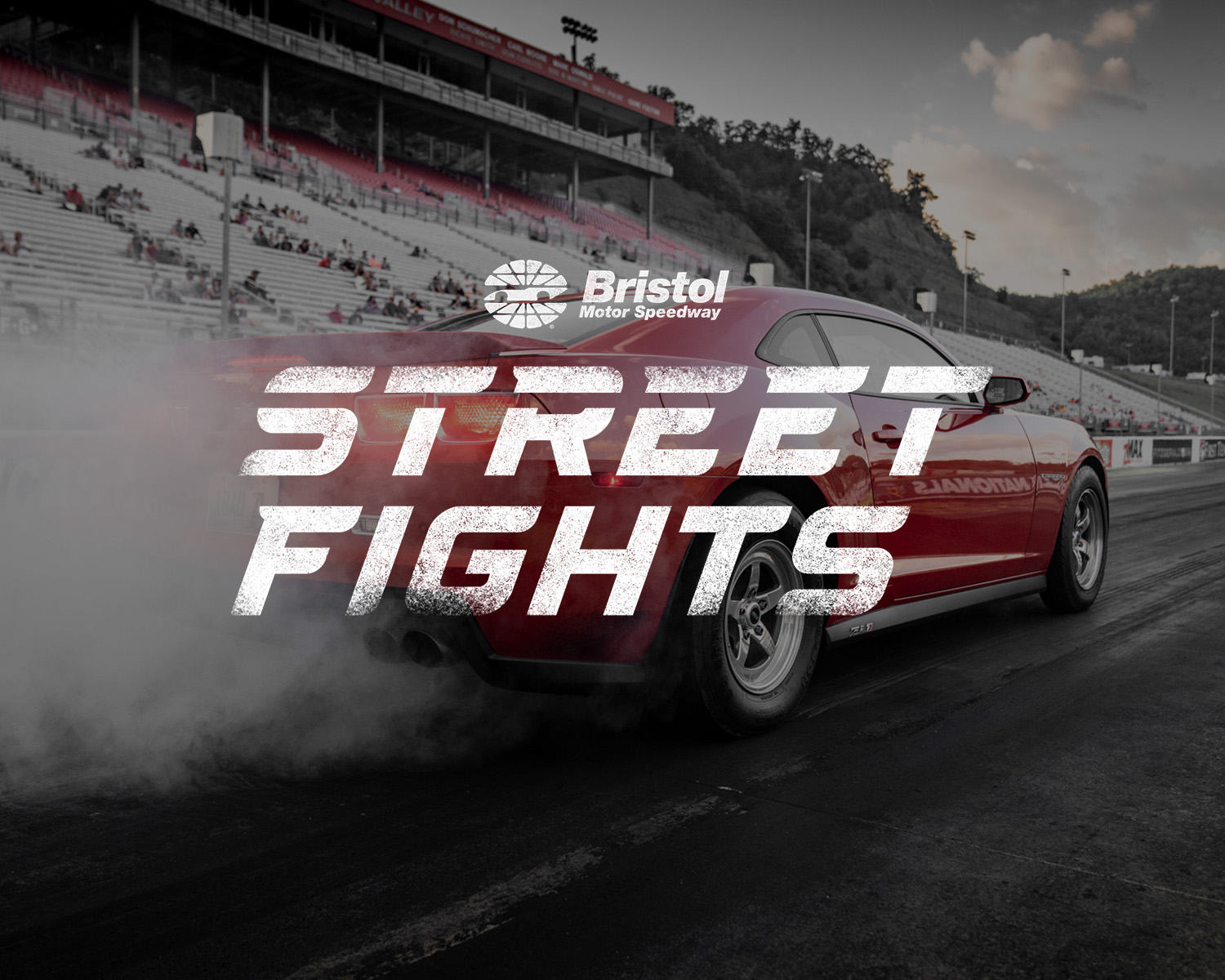 Bristol Street Fights over a photo of a red car speeding down a track.