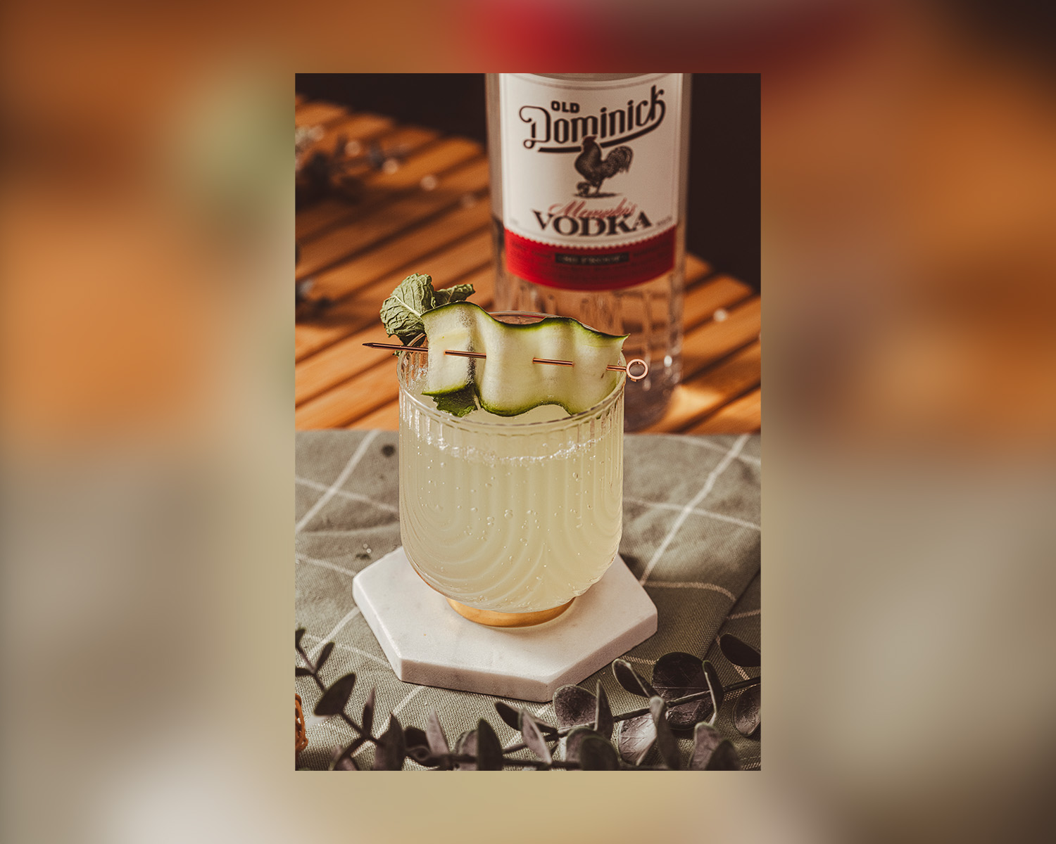 Bottle of ODD vodka next to a cocktail.