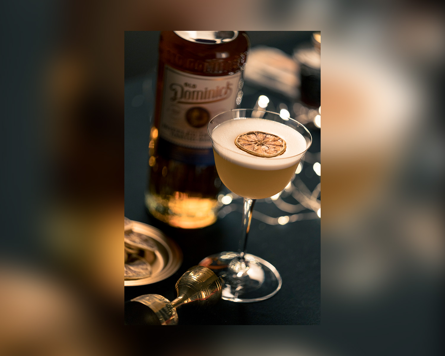 Bottle of ODD whiskey next to a cocktail.